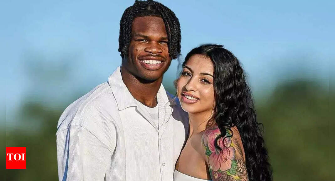 Travis Hunter and wife Leanna share adorable family moment in matching black gymwear with newborn son